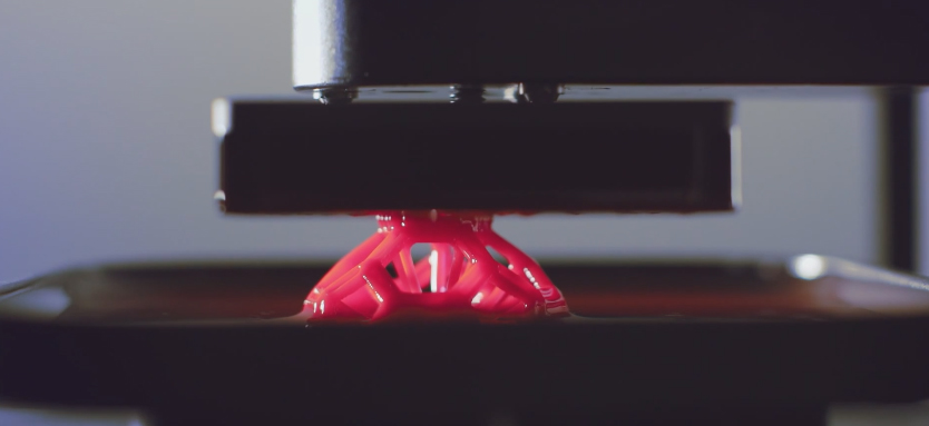 Grown, not built, an object begins to emerge from the resin pool. Courtesy of Carbon3D 
