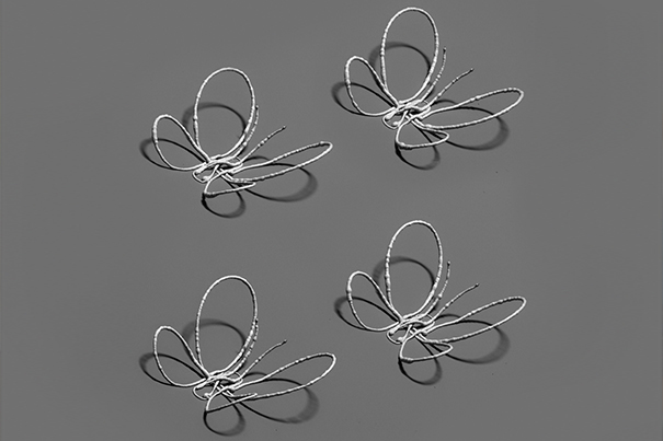 These silver butterflies were 3D printed without requiring support structures. Courtesy of Lewis Lab/Wyss Institute at Harvard University.