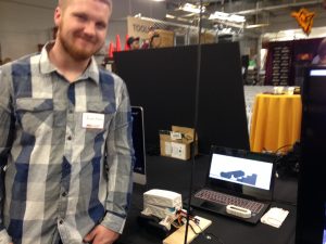 Jason Olson, ASU mechanical engineering master’s student, presenting his work on J-Bot, a Reconfigurable Autonomous Transport (RAT), prototyped with the aid of 3D printing. Image courtesy of Pamela Waterman.