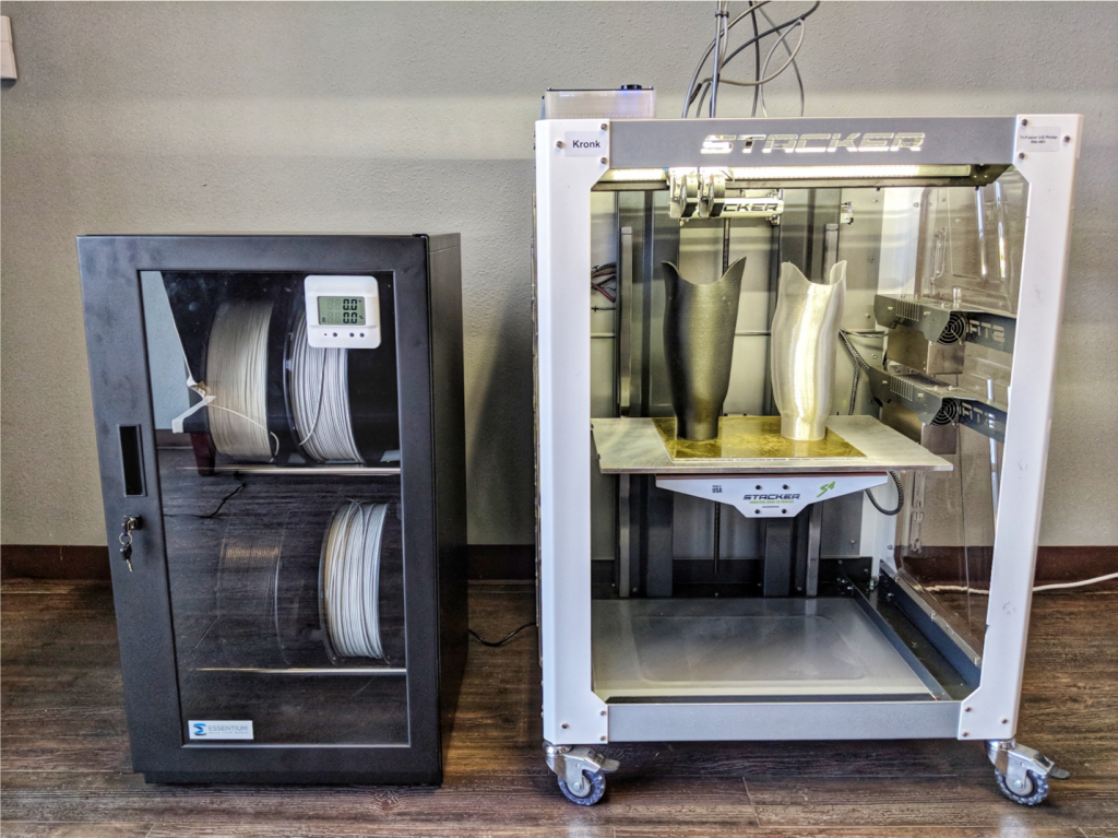 FlashFuse Studio Package 3D printer, comprising a Stacker S4 3D printer, Fusebox technology and Essentium's new Industrial DryBox. The system produces parts whose strength can be equivalent to, or greater than that of injection-molded parts. (Image courtesy Essentium)