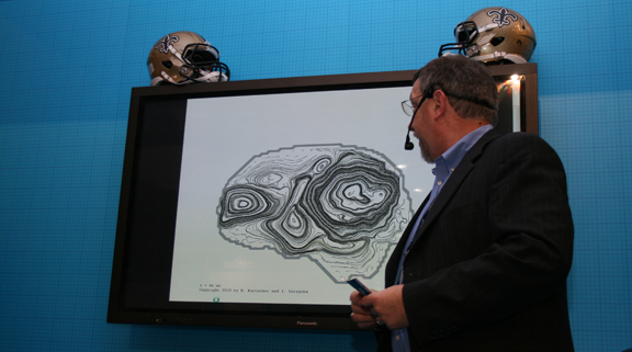 20101116SC2010fig1 John Hengeveld, marketing director for Intel's HPC Data Center Group, explains how six accelerometers in football helmets equipped with Riddell HITS (Head Impact Telemetry System) allowed on-field impact data to be collected.