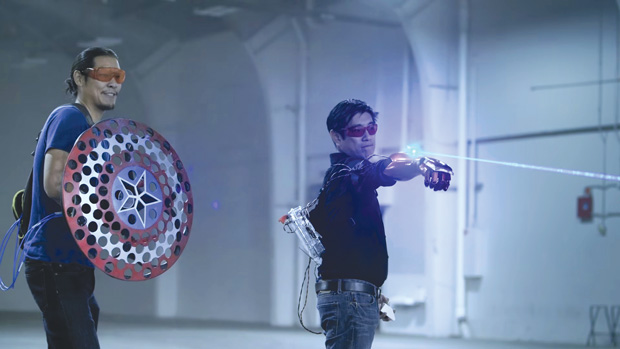 “Project Heroes” cohosts Allen Pan (left) and Grant Imahara (right) face off against each other with their own versions of Captain America’s shield and Iron Man’s glove. Image courtesy of Mouser Electronics. 