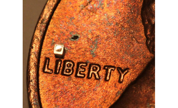 Microtech’s submillimeter sensor, dotting the “I” on a U.S. penny.