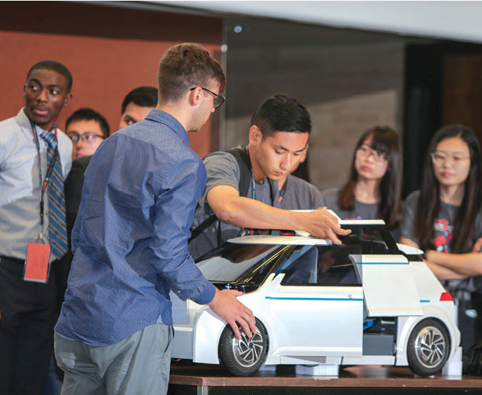 A team of international students present their Reconfigurable Shared-Use Mobility System in a future mobility competition at the PACE Annual Forum. Image Courtesy of Siemens PLM Software.