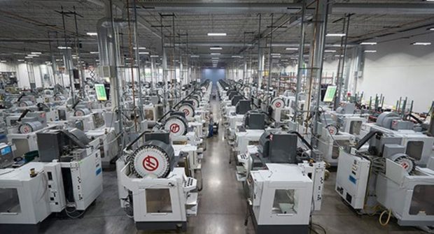 These milling machines, as well as similar arrays of injection molding presses and 3D printers, are connected to the Proto Labs network. Data collected by sensors track the progress of orders and help optimize scheduling. The monitor seen on the left displays real-time updates. Image courtesy of Proto Labs Inc.