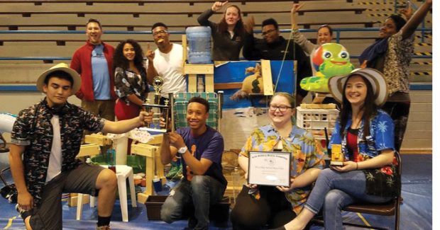 Rube Goldberg Machine Contest participants pose with their machines. Image courtesy of RGI.