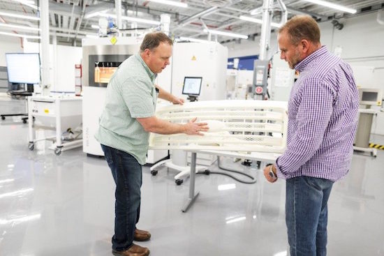Staff inspect a 3D-printed F-150 grill at Ford’s Advanced Manufacturing Center. Image courtesy Ford.